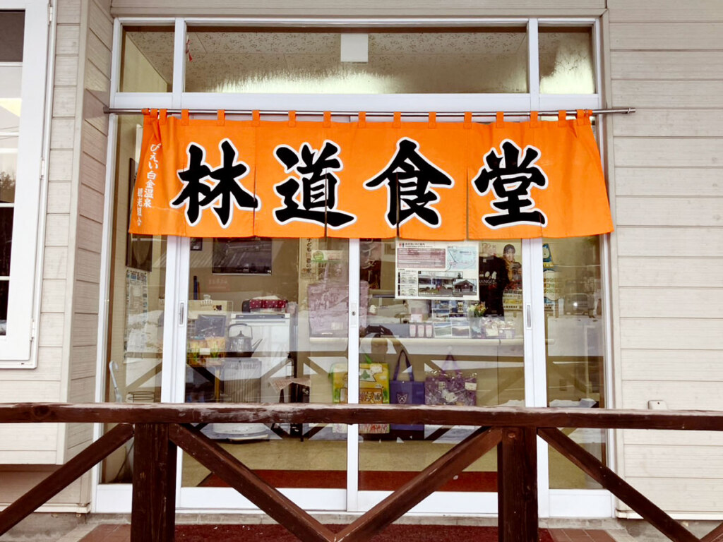 十勝岳連峰の山麓の白金温泉街に佇む唯一の食堂。一際目を引くオレンジ色の暖簾が目印です